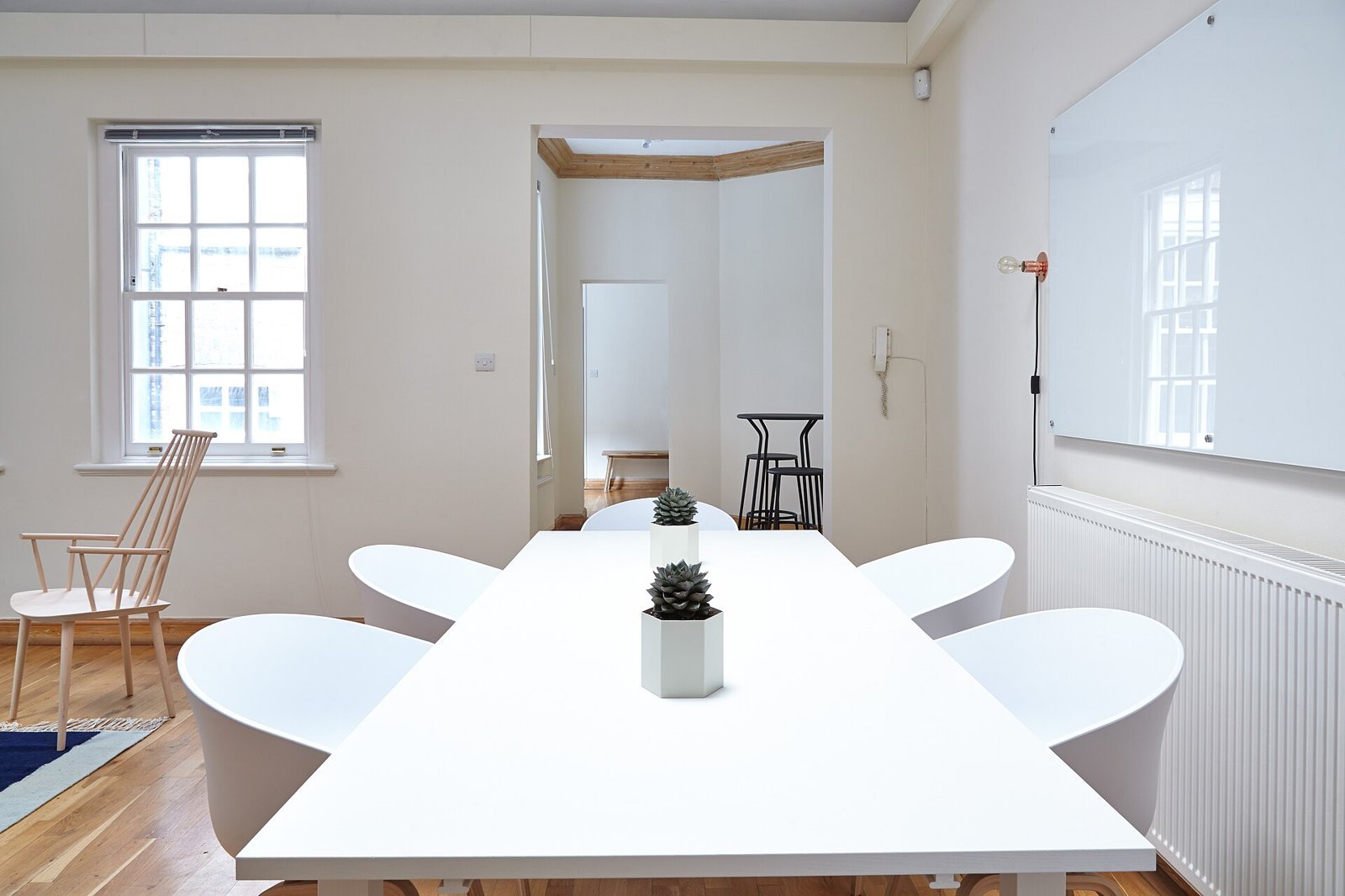 Bright, empty office with a long white table and chairs