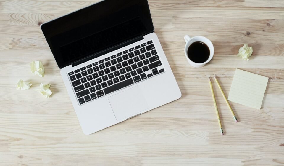 ClickUp Brain in 2026: What It Does, Super Agents, Setup Steps, and What It Costs Open laptop next to a cup of coffee on a wooden desk