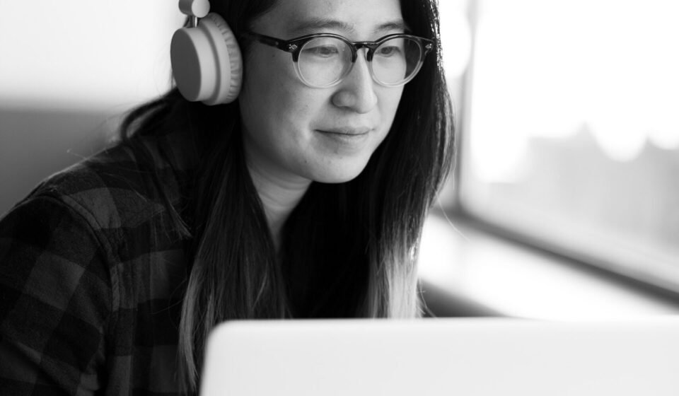 Notion AI in 2026: Agents, Autofill, Credits and What Actually Costs Money Person wearing headphones working on a laptop