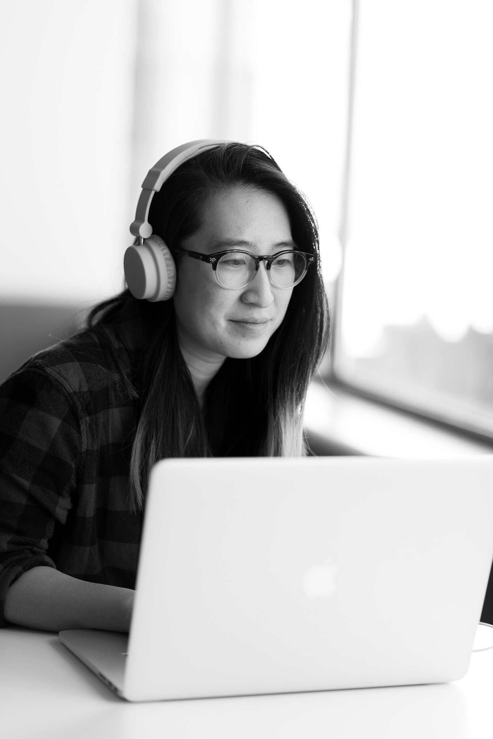 Remote worker with headphones using a laptop