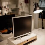 Computer monitor and desk lamp on a workspace desk