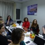Laptop on a meeting table where a team plans work together