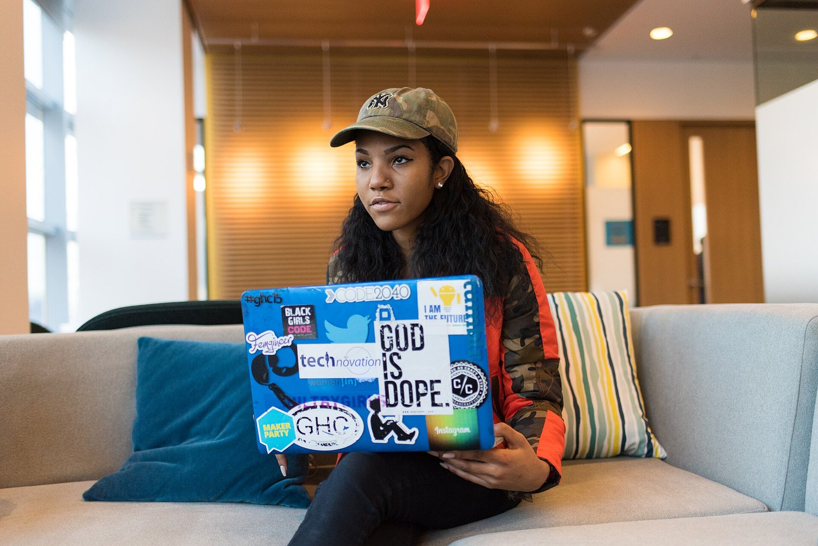 Developer working on a laptop covered in stickers