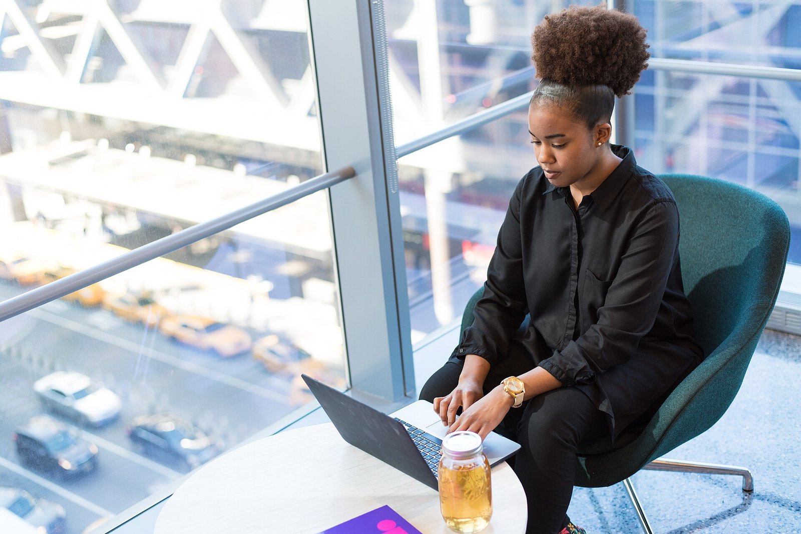 Person working on a laptop near a window