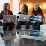 Small team working together on laptops on a couch