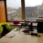 Open-plan office desks where teams handle incoming requests