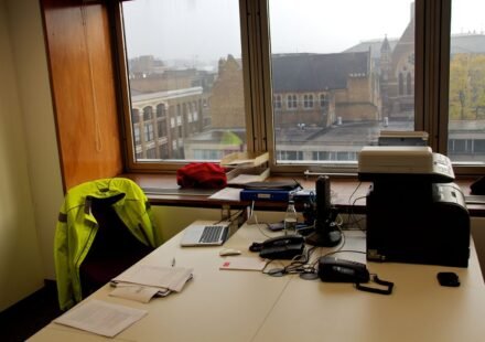 Open-plan office desks where teams handle incoming requests