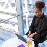 Remote worker using a laptop by a large window