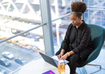 Remote worker using a laptop by a large window